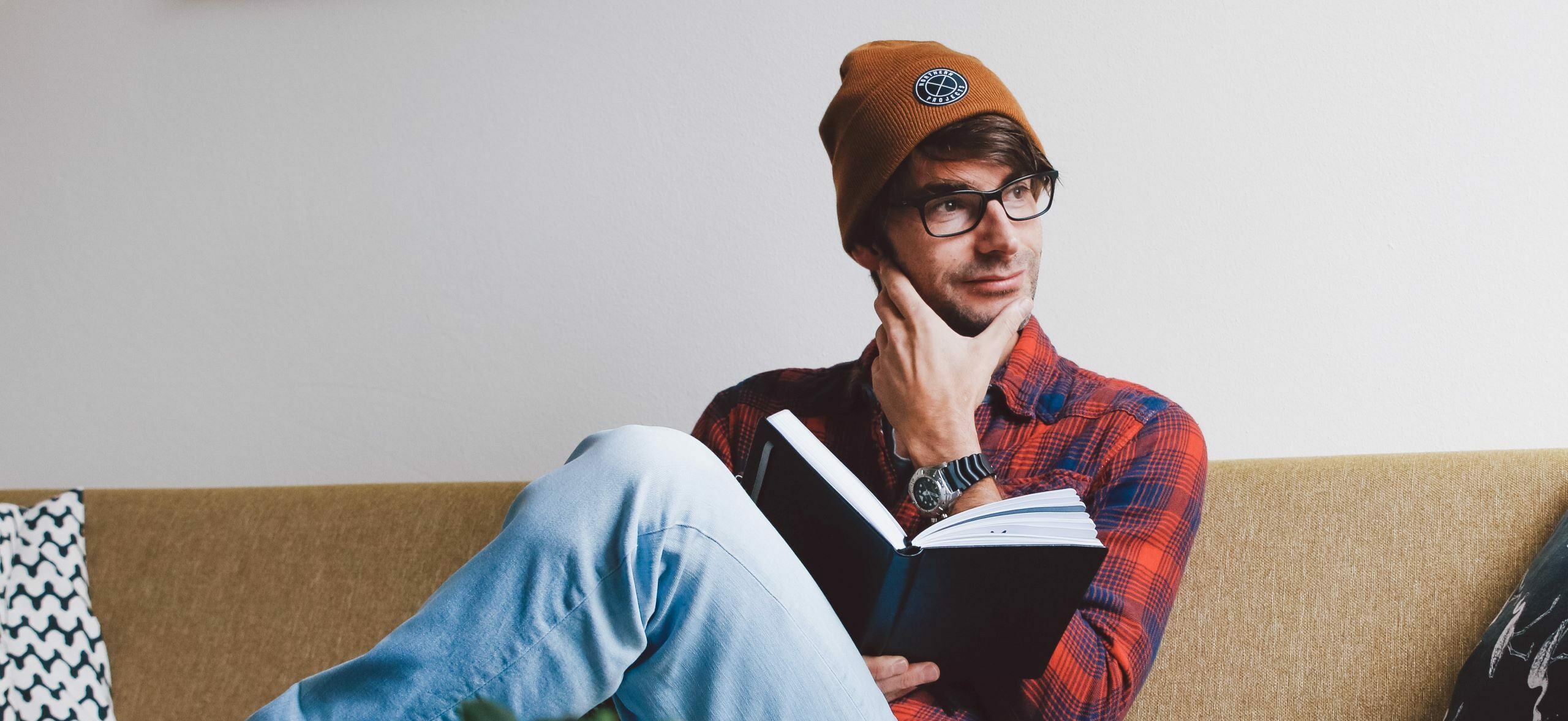 man wearing a beanie and reading