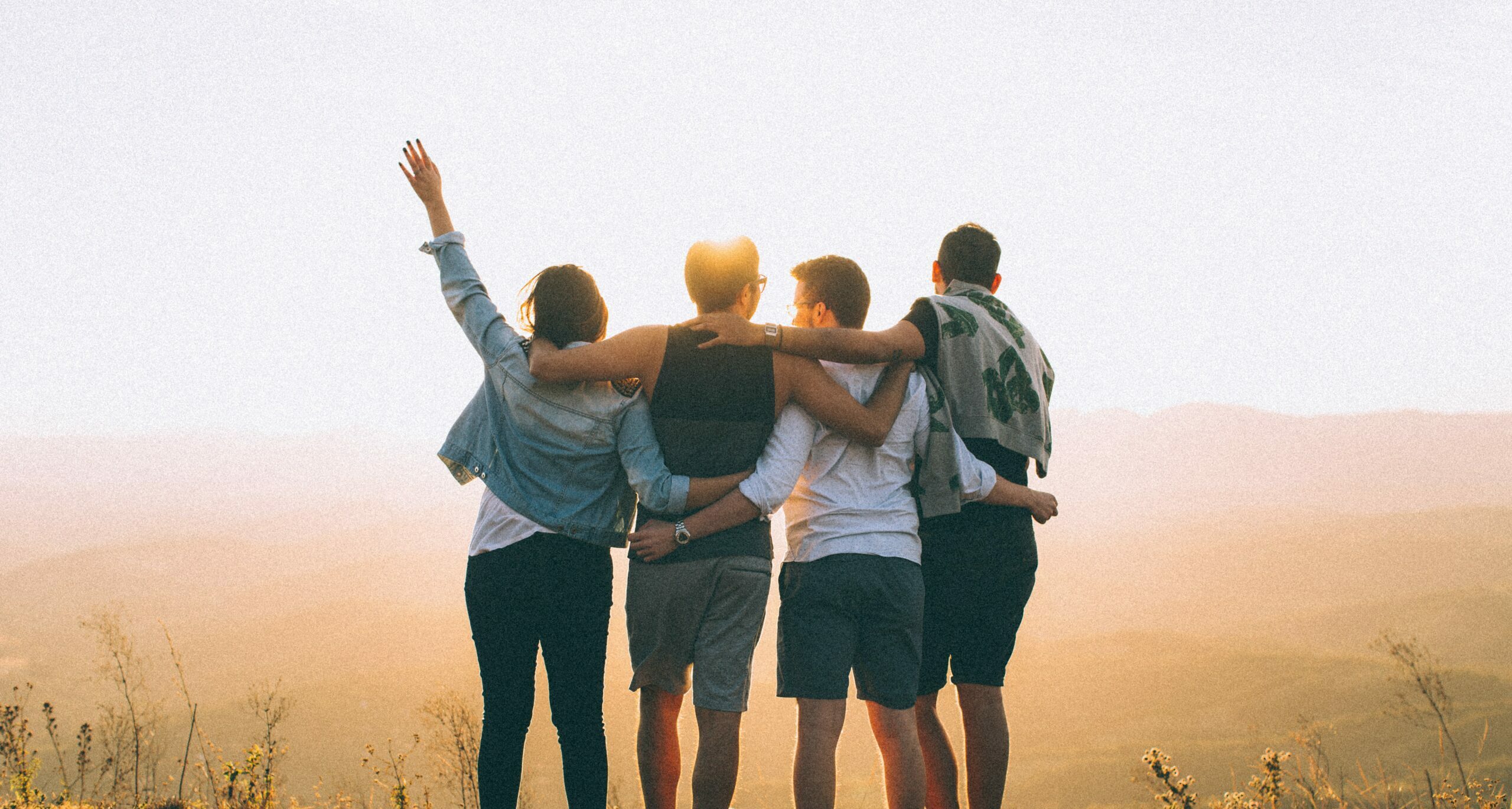 four people watching the sunset