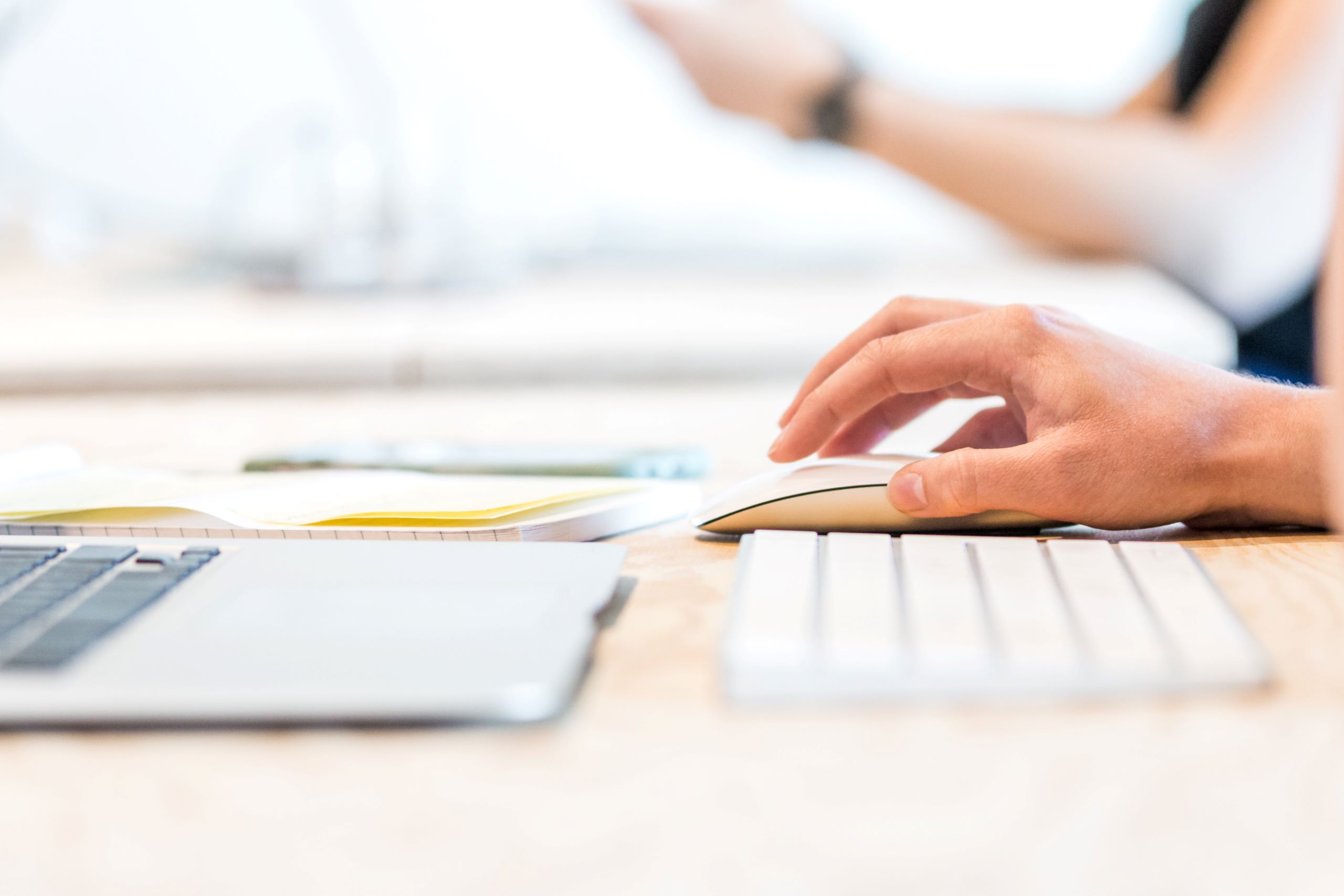 a person working at their desk with their laptop