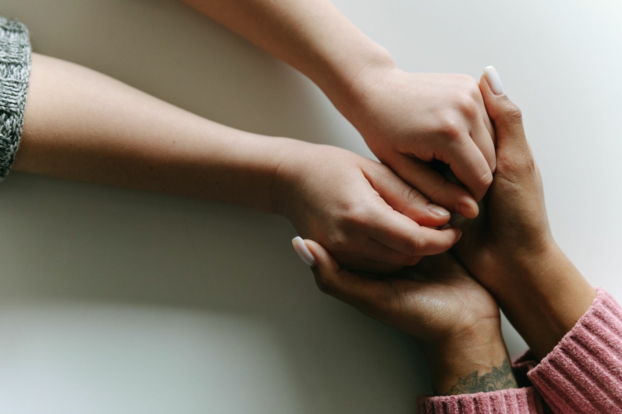 a woman holding another woman's hand