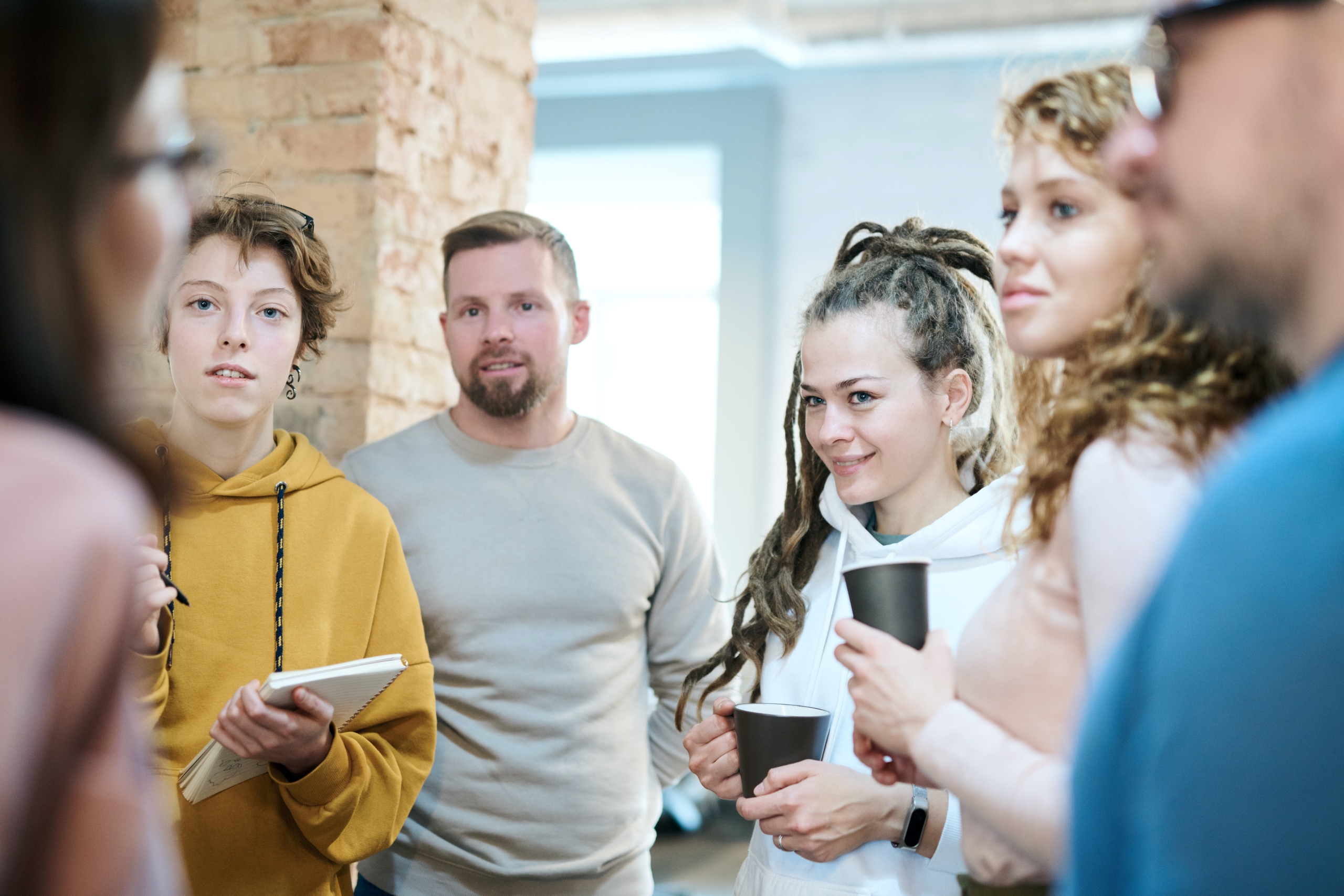 picture of a group of people listening to someone talk