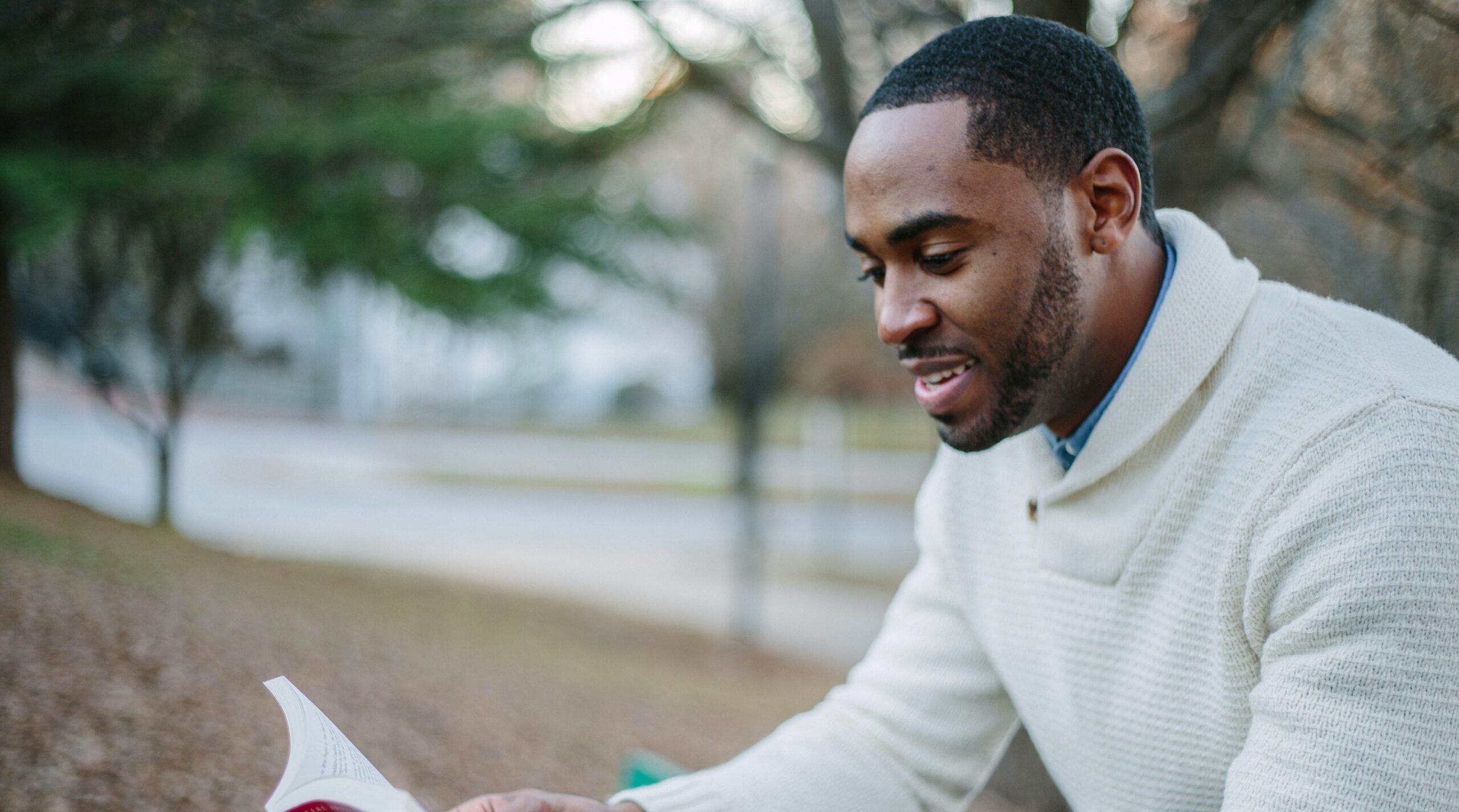 man reading in a park